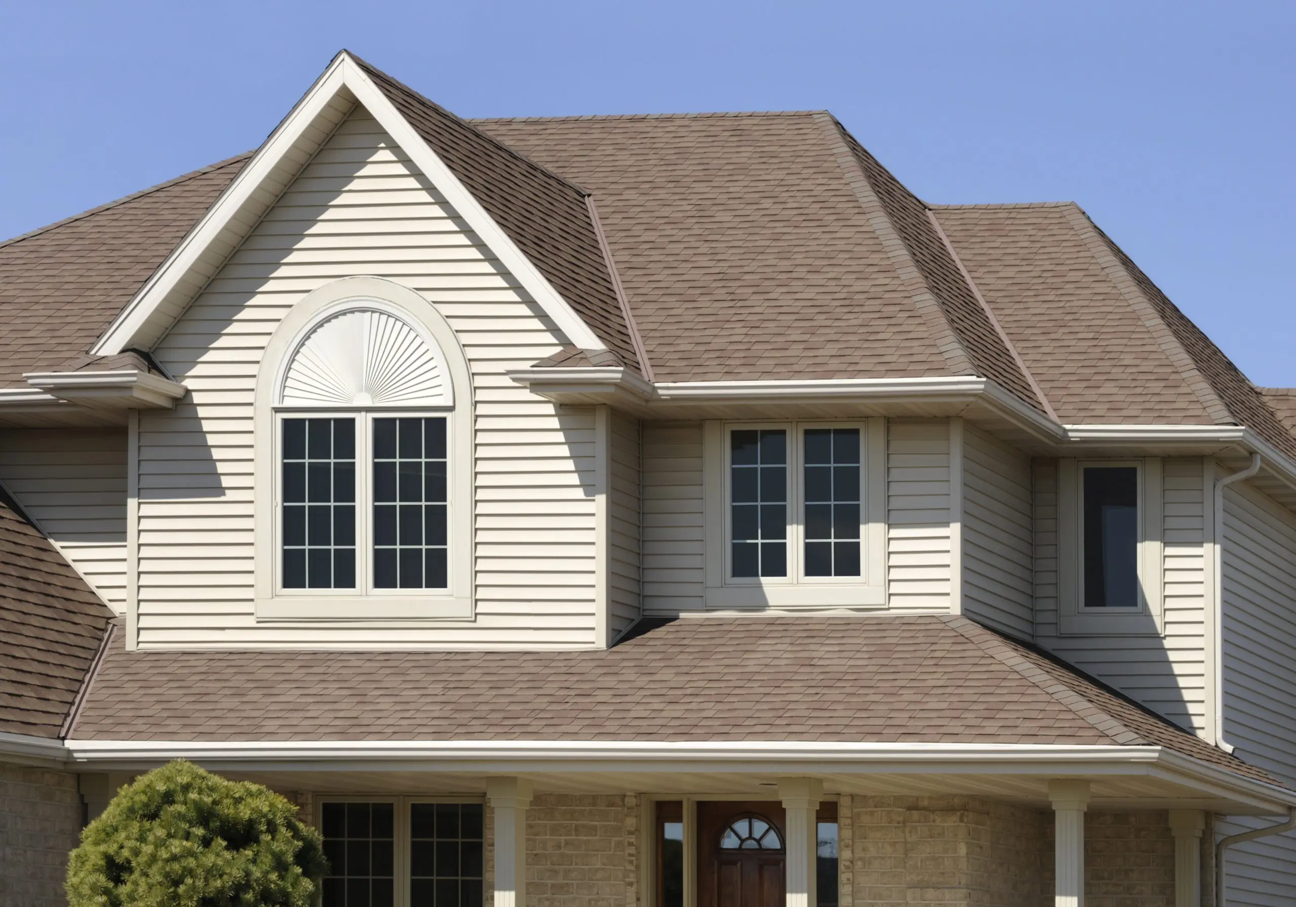 Two story tan home with beige roof