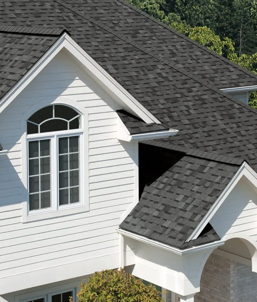 Owens Corning® Duration® shingles in Estate Gray on a white home with dormer windows.