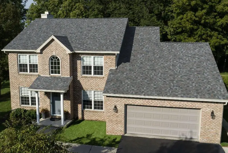 Owens Corning® gray asphalt shingles installed on a two-story brick and siding home.