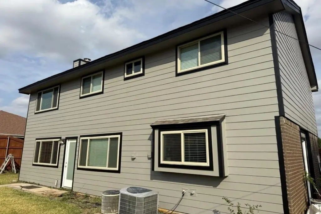 Two-story Euless, Texas home with light gray replacement siding and black-trimmed windows