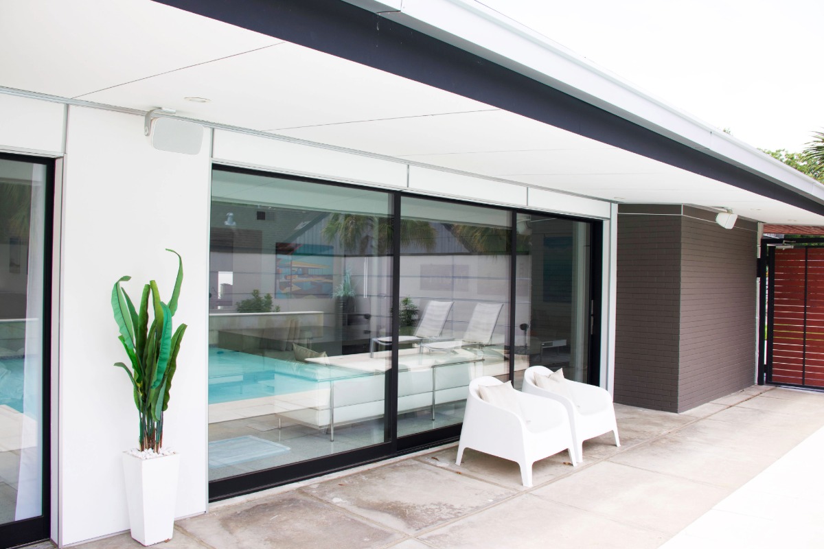 Modern three panel oversized sliding glass doors with black trim