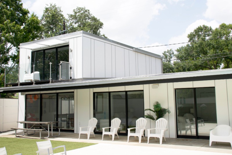 Modern home with white Hardie panel siding with sliding glass doors