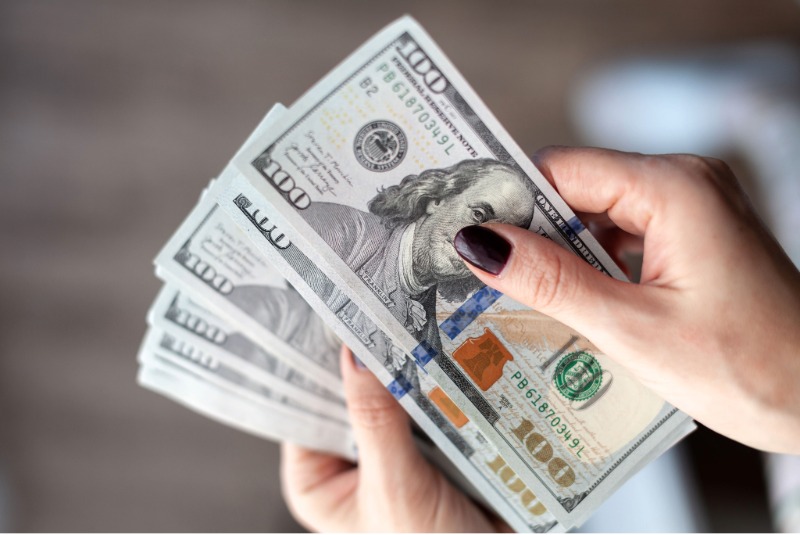 woman holding cash in hand