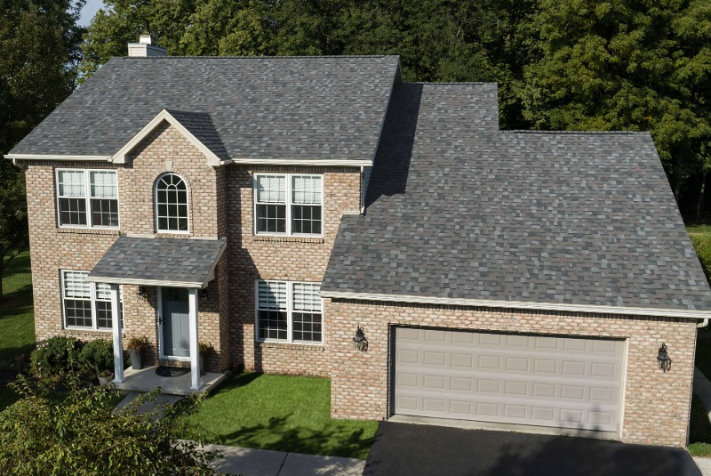 Owens Corning grey shingles on a brick two-story home