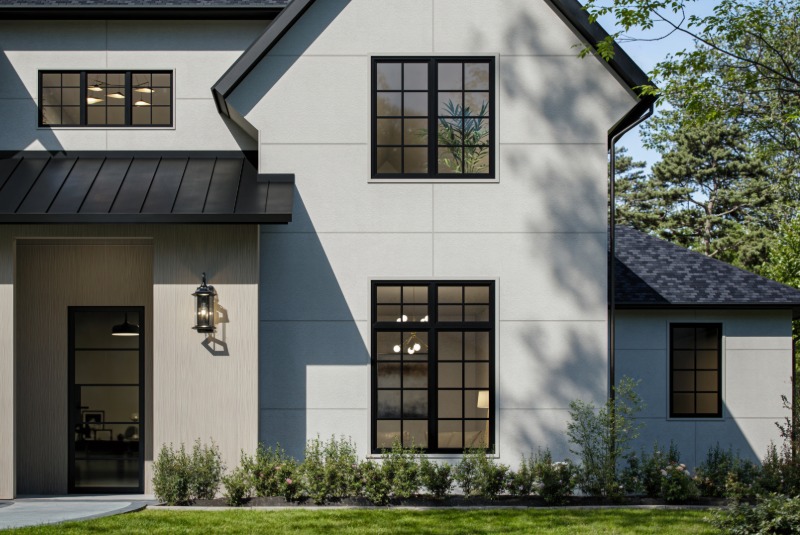 Hardie Architectural panel siding in fine sand texture with modern black windows.