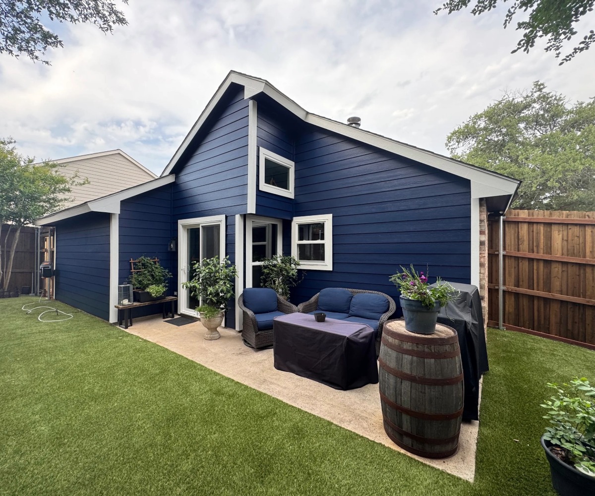 Back of a home with dark blue lap siding