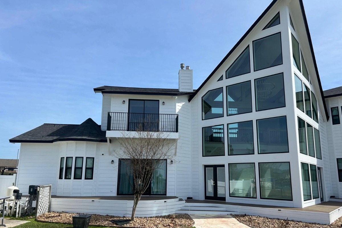 Modern home with white lap siding with black windows