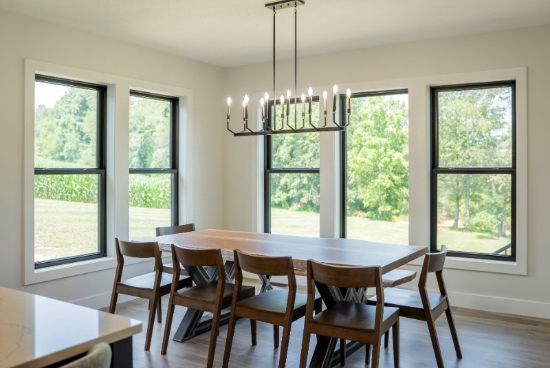 Modern dining room with black window and a dining room table