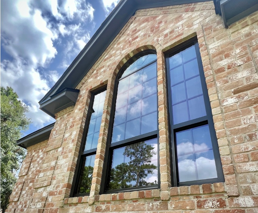 black windows on a brown brick home