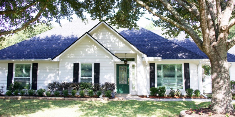 White ranch home with white vinyl replacement windows