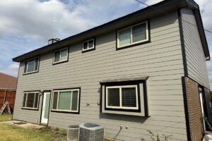 Two-story Euless, Texas home with light gray replacement siding and black-trimmed windows