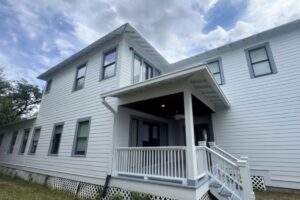 Two-story Houston home with light gray Hardie siding and white trim